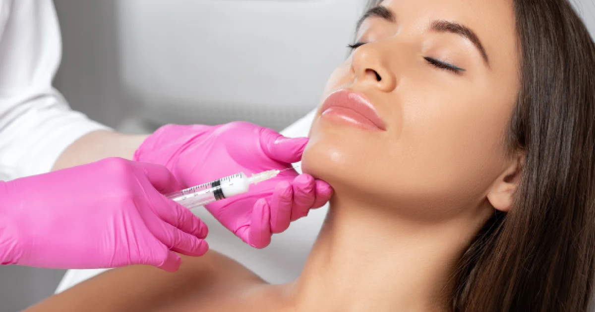 Woman receiving a Kybella injection under the chin in Denver, CO